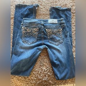 Boot cut miss me jeans holes at the bottom because I’m short